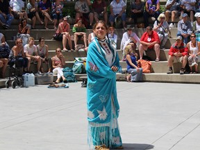 A dancer in full regalia waits for the drumming to begin in Springer Market Square in Kingston as part of National Aboriginal Day on Tuesday. (Jane Willsie/For The Whig-Standard)