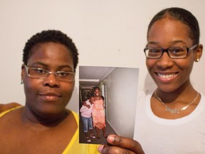 Brandy Reid's sister, Paula Reid (left) and cousin Aneke Davis hold a photo of the hit-run victim Tuesday, June 21, 2016. (Daniel McKenzie/Toronto Sun)