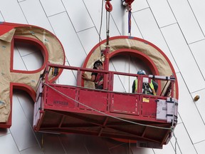 Workers place letters forming Rogers Place on to the side of the future home of the Edmonton Oilers in Edmonton on Tuesday, June 21, 2016. Ian Kucerak/Postmedia Network