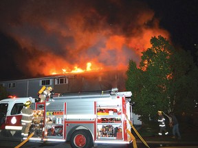 Photo by KEVIN McSHEFFREY/THE STANDARD A six-unit townhouse complex on Forest Place in Elliot Lake was severely damaged by fire Tuesday evening. At least three of the units appeared to be gutted by the flame, rendering a number of residents homeless. Two fire engines and more than a dozen firefighters were dispatched to battle the flames, and protect the neighbouring townhouse complexes