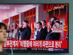 A woman walks by a public TV screen showing North Korea's leader Kim Jong Un at the Seoul Train Station in Seoul, South Korea, Wednesday, June 22, 2016. In a remarkable show of persistence, North Korea on Wednesday fired two suspected powerful new Musudan mid-range ballistic missiles, U.S. and South Korean military officials said, its fifth and sixth such attempts since April. The letters on top left, "North Korea's missile launches failed again." (AP Photo/Lee Jin-man)