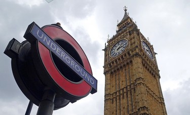 In this May 20, 2015 photo, a sign for the London Underground system appears next to  the Big Ben bell clock and Elizabeth Tower in London. (AP Photo/Ross D. Franklin)