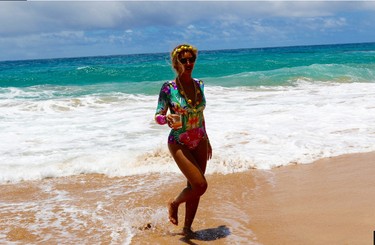 Beyonce rocks a one-piece, printed swimsuit from Mara Hoffman. He lemon-adorned headband and necklace are from Dolce & Gabbana.(Photo: Beyonce.com)