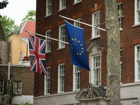A European, right, and Union flag are displayed outside Europe House, the European Parliament's British offices, in London, Wednesday, June 22, 2016. Britain votes whether to stay in the European Union in a referendum on Thursday. (AP Photo/Matt Dunham)