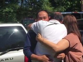The Daily Hampshire Gazette reports that 63-year-old Chhum Nget screamed before hugging his younger brother, 57-year-old Sambath Ngeth, in a tearful embrace on Tuesday outside the older man's Belchertown, Massachusetts, home. (Daily Hampshire Gazette/YouTube screengrab)