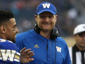 Winnipeg Blue Bombers head coach Mike O’Shea, joking with RB Andrew Harris during a CFL pre-season game against the Montreal Alouettes in Winnipeg on June 8, 2016, is on the hotseat. (Kevin King/Postmedia Network)