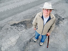 Luke Hendry/The Intelligencer
Karl Street resident Mac Ellis stands outside his home in. The street is among those receiving limited patching. Ellis had complained the surface was broken and uneven, making it unsafe for some people to walk.