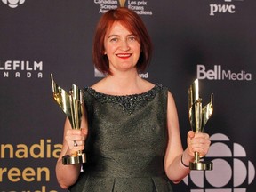 Author Emma Donoghue holds two awards for the film Room while backstage at the 2016 Canadian Screen Awards in Toronto on March 13.
(Fred Thornhill/Reuters)