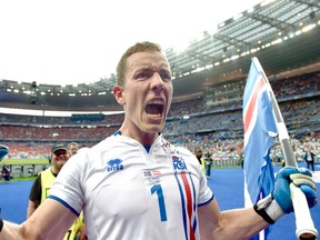 Iceland goalkeeper Hannes Halldorsson holds his country’s flag while celebrating after their Euro 2016 win over Austria at the Stade de France in Saint-Denis, France, Wednesday, June 22, 2016. (AP Photo/Martin Meissner)