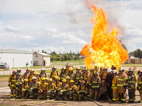 Volunteer firefighters, from surrounding communities, push against a controlled inferno, during one one of 12 modules of the NFPA 1001 training, at the Vermilion Emergency Training Centre on Sunday, June 12. Taylor Hermiston/Vermilion Standard/Postmedia Network.