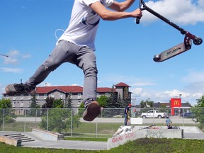 Easton Long, a regular user of the skate park, performs a trick on his scooter on June 19. Long said an expansion to the skate park would help all of its users.