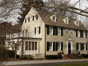 Real estate photograph of a house located at 112 Ocean Avenue in the town of Amityville, New York March 31, 2005. The Amityville Horror house rich history and beauty are overshadowed by the story of George and Kathy Lutz, the previous residents of 112 Ocean Avenue, who claimed that shortly after moving into the house they fled in terror driven out by paranormal activity. The best selling novel and popular movie have marked the town as the site of the most famous haunted house in history, yet many are unaware that the true history of this house is much darker than 'The Amityville Horror's' icy drafts and bleeding walls. Six members of the DeFeo family were murdered at 112 Ocean Avenue one year before the Lutz family moved in and their tragedy haunts the citizens of Amityville to this day. (Photo by Paul Hawthorne/Getty Images)