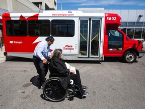 ParaTranso driver Cesar Calderon helps user, Rachidi Mourad, to the bus on her way home from the Ottawa Hospital. Darren Brown/Postmedia
