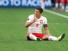 Poland's Robert Lewandowski sits on the pitch during a Euro 2016 Group C soccer match between Ukraine and Poland at the Velodrome stadium in Marseille, France, on June 21, 2016. (AP Photo/Thanassis Stavrakis)