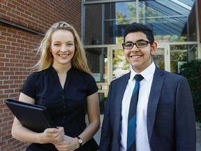 Outgoing Algonquin Lakeshore Catholic District School Board student trustee Danae O'Neill poses for a photo with incoming student trustee George Hinin outside the board office in Napanee on Tuesday before the final general board meeting of the 2015-2016 school year. (Julia McKay/The Whig-Standard)