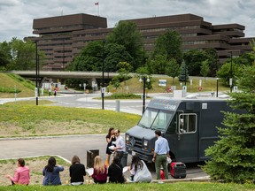 People line up at a food truck during the lunch hour in a parking near King Edward Avenue and Union Street behind the Global Affairs Canada building on Sussex Drive. Errol McGihon/Postmedia