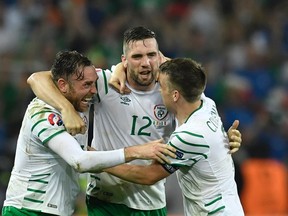 Ireland’s players celebrate after scoring during their Euro 2016 match against Italy at the Pierre-Mauroy stadium in Villeneuve-d’Ascq on June 22, 2016. (AFP PHOTO PHILIPPE LOPEZ)