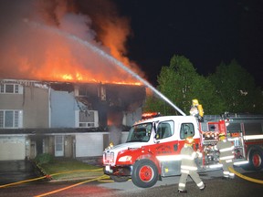 Photo by KEVIN McSHEFFREY/THE STANDARD
A six-unit townhouse complex on Forest Place in Elliot Lake was severely damaged by fire Tuesday evening. All the units received damage, rendering a number of residents homeless. Two fire engines and more than a dozen firefighters were dispatched to battle the flames, and protect the neighbouring townhouse complexes.