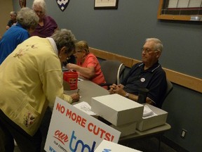 Ernst Kuglin/The Intelligencer
Residents continue to sign membership forms for Our TMH. ”Our voice needs to get stronger,” said Our TMH chair Mike Cowan. About 80 people were at Wednesday’s information meeting in Trenton.