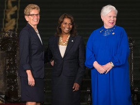 Ontario Premier Kathleen Wynne, left, and Lt.-Gov. Elizabeth Dowdeswell, right, pose for a photo with Associate Minister of Finance (Ontario Retirement Pension Plan) Indira Naidoo-Harris after her swearing-in at Queen's Park in Toronto on Monday, June 13, 2016. (THE CANADIAN PRESS/Peter Power)