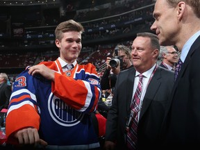 NEWARK, NJ - JUNE 30: Marc-Olivier Roy (L), drafted #56 overall in the second round by the Edmonton Oilers, puts on his new Edmonton jersey during the 2013 NHL Draft at the Prudential Center on June 30, 2013 in Newark, New Jersey.  Bruce Bennett/Getty Images/AFP