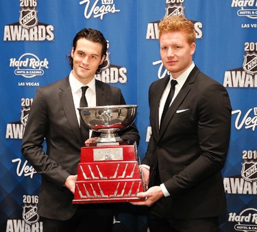 Anaheim Ducks goalie John Gibson, left, and goalie Frederik Anderson pose with the William M. Jennings Trophy after winning the award at the NHL Awards show, Wednesday, June 22, 2016, in Las Vegas. (AP Photo/John Locher)