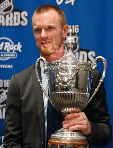 Vancouver Canucks' Henrik Sedin, from Sweden, holds the King Clancy Memorial Trophy at the NHL Awards show, Wednesday, June 22, 2016, in Las Vegas. (AP Photo/John Locher)
