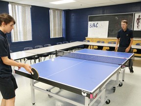 Nick Durkac, left, and Parker Savard, of Bishop Alexander Carter Catholic Secondary School in Hanmer, Ont., play a game of table tennis at the school on Wednesday June 22, 2016. John Lappa/Sudbury Star/Postmedia Network