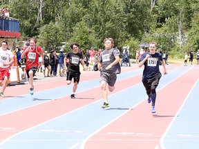 Grant Higgins of Churchill Public School leads runners over the line during the grade 8 boys 100 meter dash at the R.E. Gibson Memorial Champions Meet at the Laurentian Community Track Complex in Sudbury, Ont. on Tuesday June 21, 2016. Gino Donato/Sudbury Star/Postmedia Network