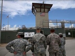 Military officers stand at the entrance to Camp VI and V at the U.S. military prison for 'enemy combatants' on June 25, 2013 in Guantanamo Bay, Cuba. (Joe Raedle/Getty Images)