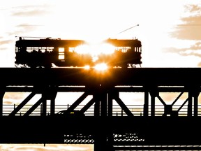 The High Level Bridge Streetcar makes its way over the High Level Bridge as the sun sets in Edmonton, Alta. on Thursday, Aug. 20, 2015. FILE PHOTO