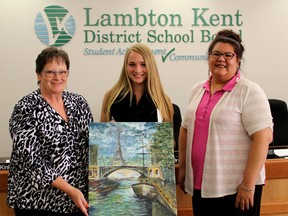 Submitted photo: Lambton Kent District School Board chair Jane Bryce, left, and First Nation trustee Lareina Rising congratulate Wallaceburg District  Secondary School Grade 11 student Ashlyn Dolbear. Dolbear was one of three LKDSB students who will have their art work on the walls of the school board's Chatham office. Dolbear was also one of six winners at the Wallaceburg schools art show held on June 15 at the Wallaceburg and District Museum. Other winners included: Sloan, Jenna Isaac, Cameron Morse, Kaylea Sands and Marisa Sands. The art from the various schools will be on display at the museum until July 8.