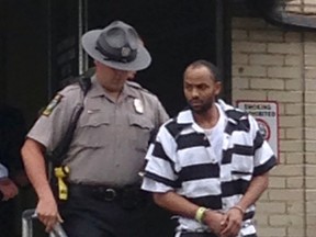 Cheron Shelton is escorted from the Allegheny County Police headquarters in Pittsburgh, Thursday, June 23, 2016. Authorities have charged Shelton and Robert Thomas with multiple counts of criminal homicide for a March ambush at a backyard cookout in Wilkinsburg. (AP Photo)