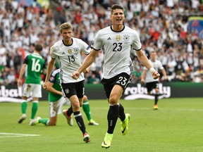Germany's Mario Gomez celebrates after scoring the opening goal during the Euro 2016 Group C soccer match between Northern Ireland and Germany at the Parc des Princes stadium in Paris, France, Tuesday, June 21, 2016. (AP Photo/Martin Meissner)