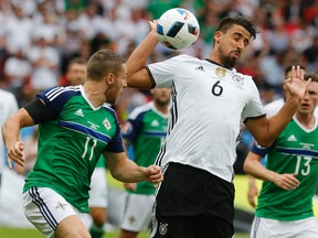 Germany’s Sami Khedira goes for the ball with Northern Ireland’s Conor Washington, left, during Euro 2016 at the Parc des Princes stadium in Paris Tuesday, June 21, 2016. (AP Photo/Michael Probst)