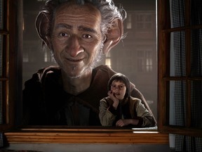 Ruby Barnhill portraying Sophie, right, appears in a scene with the Big Friendly Giant, voiced by Mark Rylance in "The BFG."