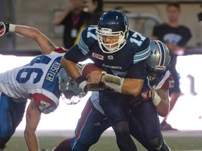 Toronto Argonauts' Cody Fajardo tries to outrun the Montreal Alouettes defence during first-quarter CFL action in Montreal on June 17, 2016. (THE CANADIAN PRESS/Peter McCabe)