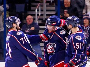 Nick Foligno and Fedor Tyutin congratulate their Columbus Blue Jackets teammate Scott Hartnell after scoring a hat trick goal on March 24, 2015 at Nationwide Arena in Columbus, Ohio. Jackets GM Jarmo Kekalainen has been aggressive working the phones leading up to the 2016 NHL Draft. (Kirk Irwin/Getty Images/AFP)