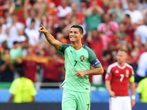 Portugal forward Cristiano Ronaldo celebrates after scoring a goal during a Euro 2016 Group F match between Hungary and Portugal at the Parc Olympique Lyonnais stadium in Decines-Charpieu, near Lyon, on June 22, 2016. (AFP PHOTO/FRANCISCO LEONG)