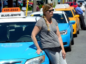 Taxi driver Carrie Baker says her business has been cut 50 percent since the arrival of the Uber taxi service in London. That in turn has caused the value of her taxi plate to drop dramatically. (MORRIS LAMONT, The London Free Press)