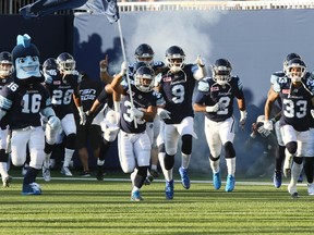 The Argonauts rumble out of the tunnel and on to the field for their first regular-season game at BMO Field, a home-opener against the rival Hamilton Tiger-Cats on Friday night. (VERONICA HENRI/TORONTO SUN)