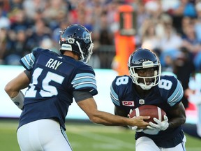 Argos quarterback Ricky Ray hands off the wide receiver Kenny Shaw during last night’s game against the Ticats at BMO Field. (VERONICA HENRI/TORONTO SUN)