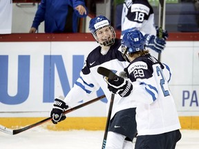 Jesse Puljujarvi and Patrik Laine bring different attributes to the table, says Canucks GM Jim Benning. (AP Photo)