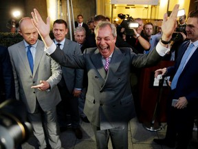 Nigel Farage, the leader of the UK Independence Party celebrates and poses for photographers as he leaves a "Leave.EU" organization party for the British European Union membership referendum in London, Friday, June 24, 2016. On Thursday, Britain voted in a national referendum on whether to stay inside the EU. (AP Photo/Matt Dunham)