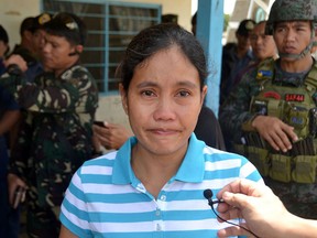 Marites Flor is seen after she was released by Abu Sayyaf militants in Jolo, the southern island of Mindanao, on June 24, 2016. Flor, a Filipina held hostage by extremists, was released from captivity on June 24, police said, a week after her Canadian boyfriend was beheaded by the gunmen. (STR/AFP/Getty Images)