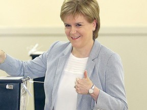 Scotland First Minister Nicola Sturgeon casts her vote in Glasgow, Scotland, Thursday June 23, 2016, as voters head to the polls across the United Kingdom in a historic referendum on whether the UK should remain a member of the European Union or leave. (Jane Barlow/PA via AP)