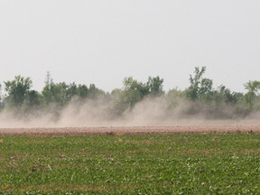 Farmer tilling his field during the regional drought of 2012. Postmedia