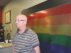Mickey Wilson stands in the office of the Pride Centre of Edmonton on June 21. He says the Orlando shooting has opened the eyes of the younger generation that there is still hatred and violence towards the LGBTQ community. - Photo by Marcia Love