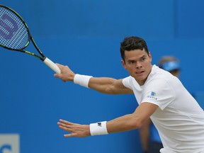 Canada’s Milos Raonic plays a return to Britain’s Andy Murray during the final of the Queen’s Championships in London Sunday June 19, 2016. (AP Photo/Tim Ireland)