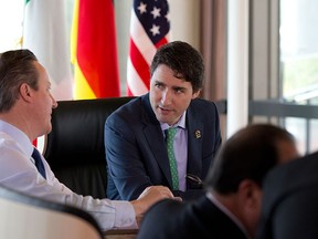 British Prime Minister David Cameron, left, and Canadian Prime Minister Justin Trudeau, talk as they prepare to participate in a G7 Working Session in Shima, Japan, Friday, May 27, 2016, during the G7 Summit. (AP File Photo/Carolyn Kaster, Pool)